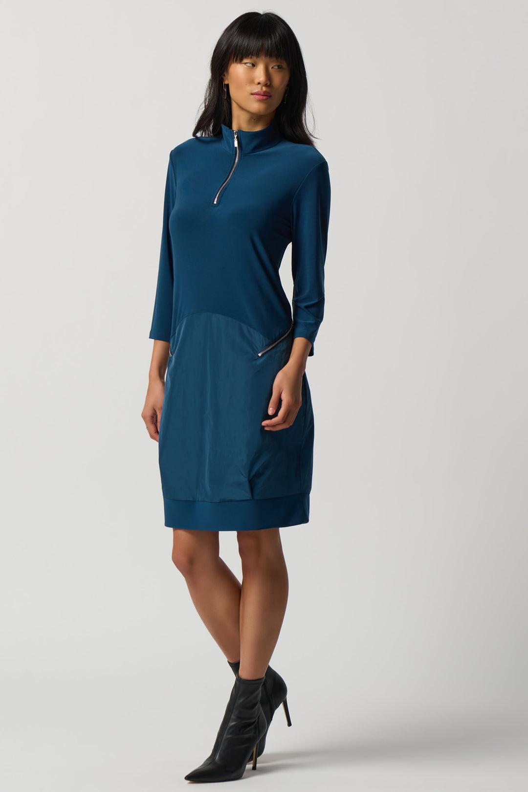 Its figure-hugging fit is designed to flatter any shape, while the zip details at the waist and collar add a tasteful touch of style. 