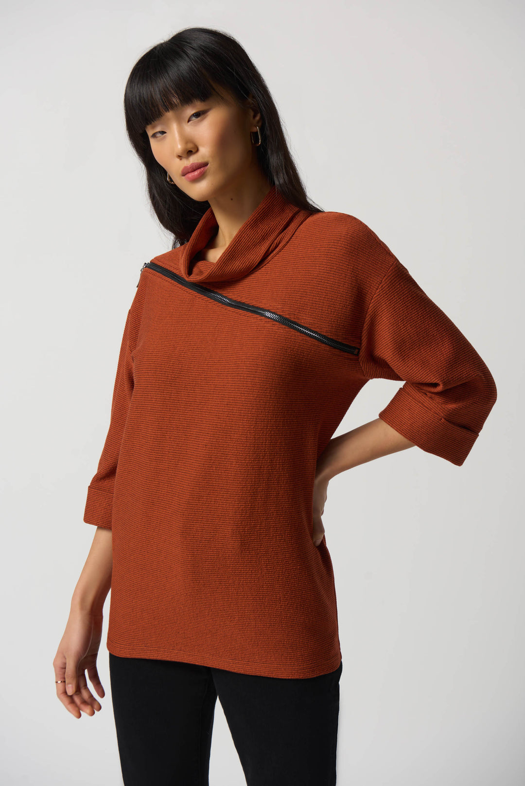 The cowl neck and 3/4 sleeves create an elegant silhouette, while the diagonally placed zipper lends a unique edge to this piece.