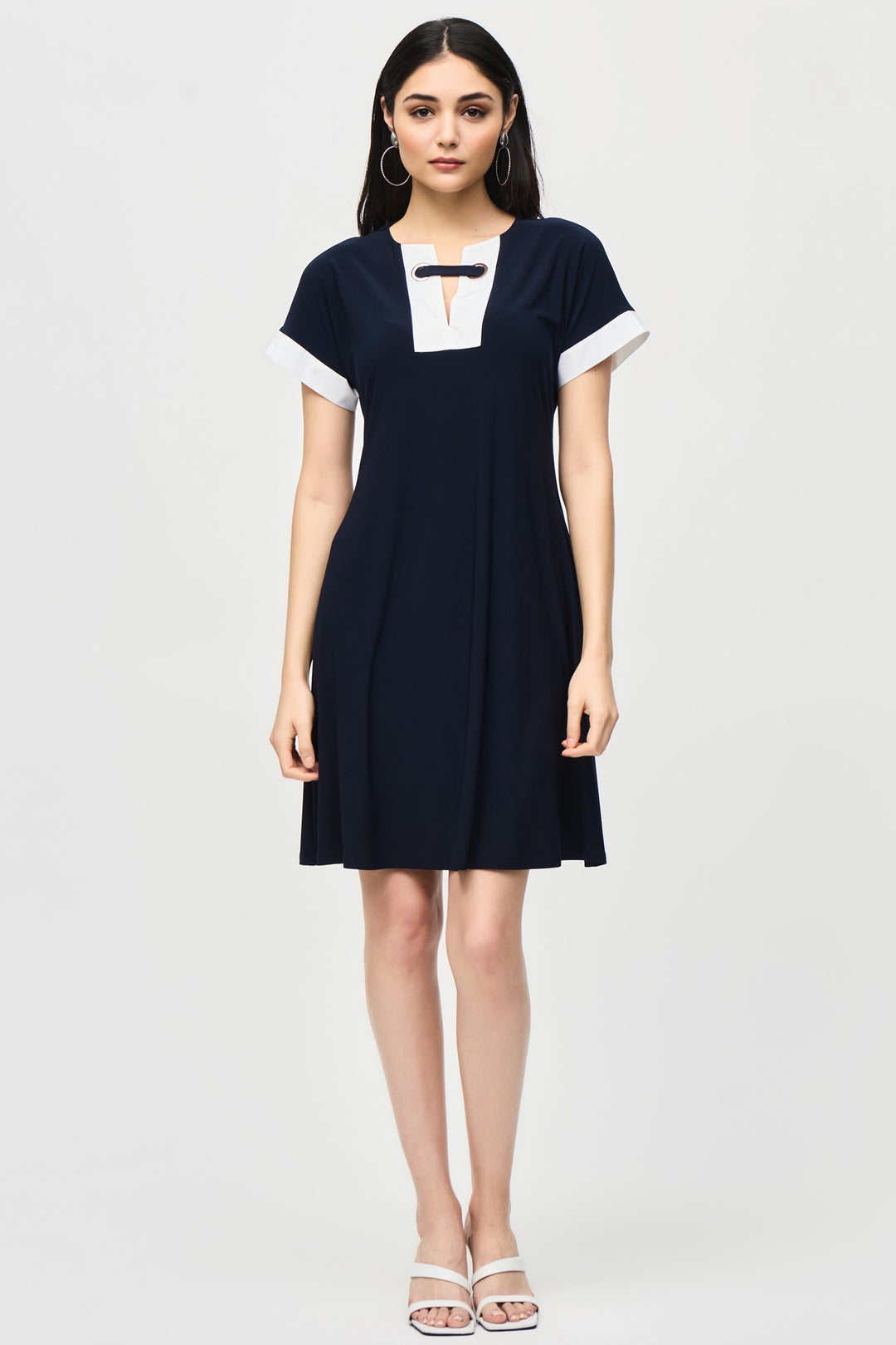 Joseph Ribkoff Summer 2024  Made from soft knit fabric, it falls above the knee and includes side seam pockets for added convenience. Stay stylish and comfortable with this versatile dress. 