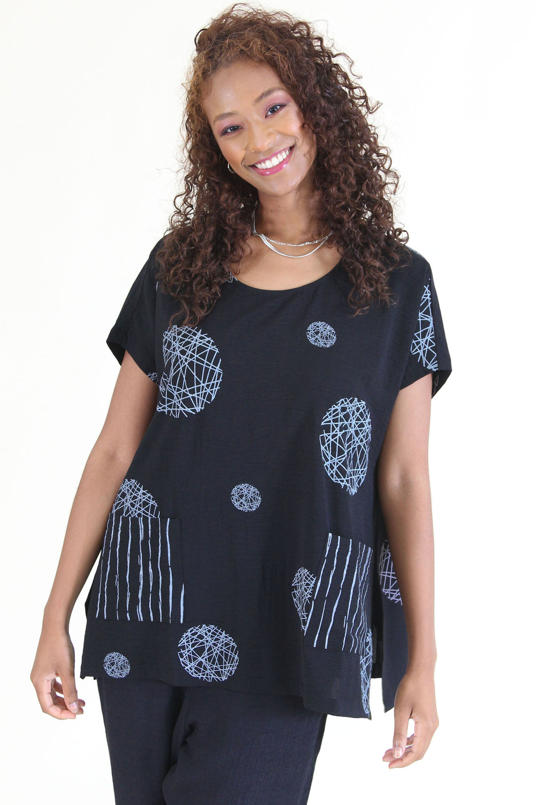 Fashion Concepts Summer 2024  This versatile top features two large front patch pockets, short dolman sleeves and a neat circles design pattern.