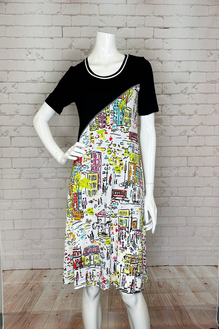 The Love The City Short Sleeve Dress With Contrast Top is a eye-catching knee-length piece with a bold black contrast top portion and a colourful city abstract print below. 