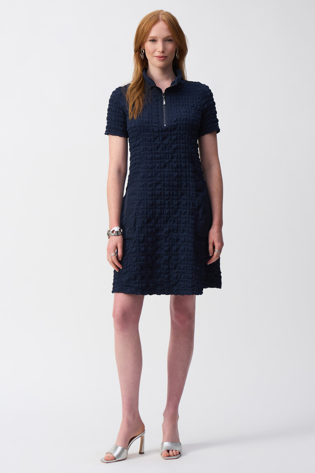 Joseph Ribkoff Spring 2025 With its slight athleisure influence, this Joseph Ribkoff dress is a sophisticated-meets-sporty style! It features a zip collar, short sleeves and pockets for your comfort and convenience.