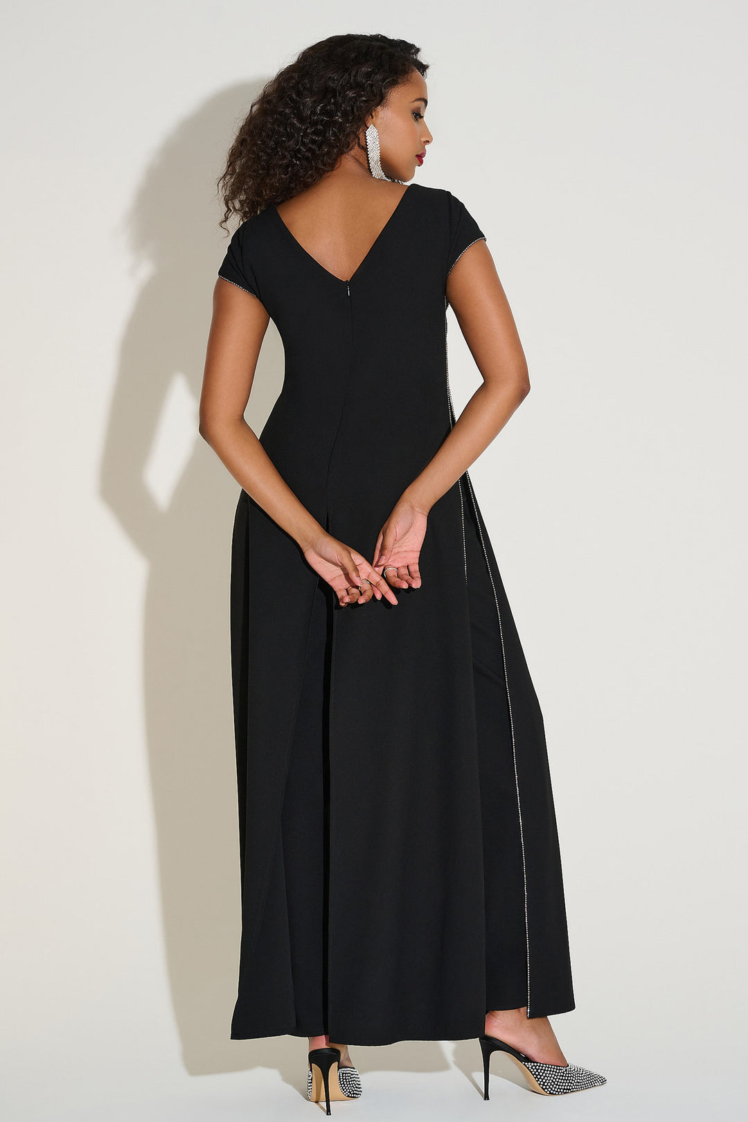 Woman wearing a black dress against a white background