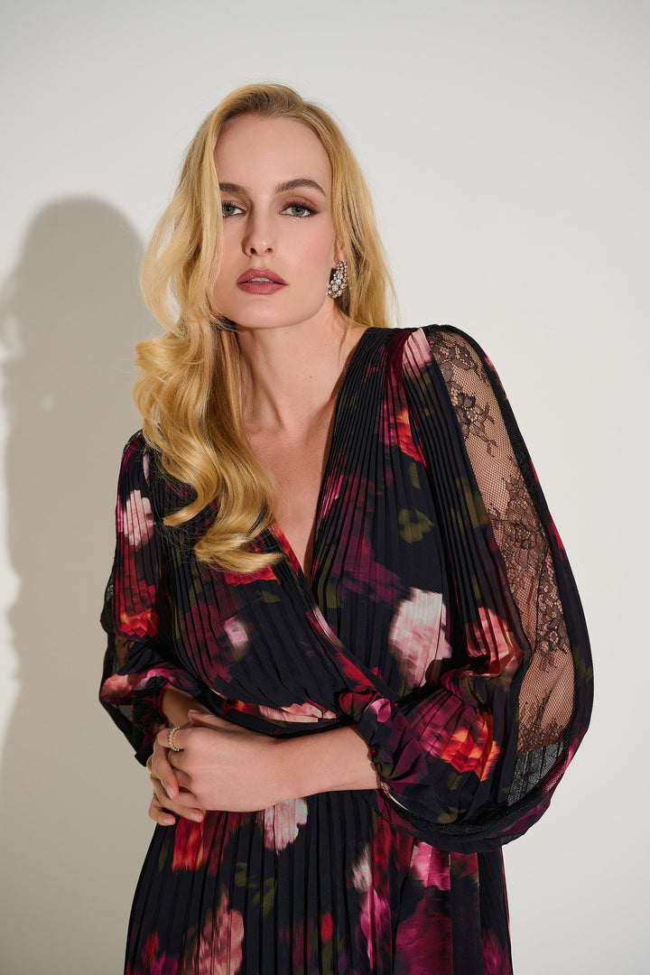 Woman wearing a floral dress with sheer sleeves against a white background