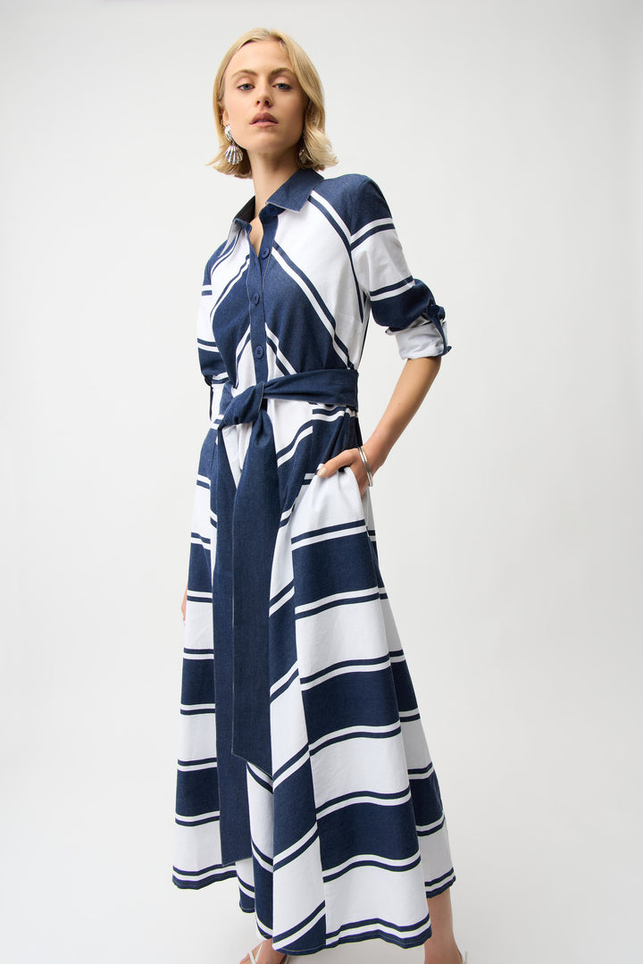 Woman wearing a blue and white striped cotton dress with belt on a white background