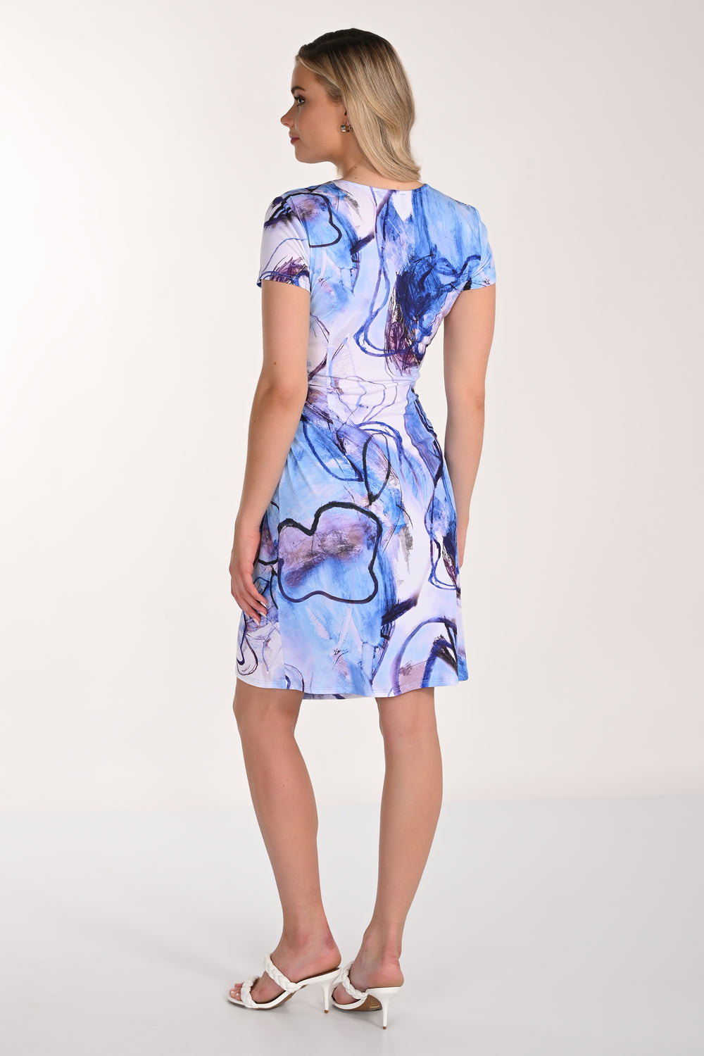 Woman wearing a blue floral dress on a white background