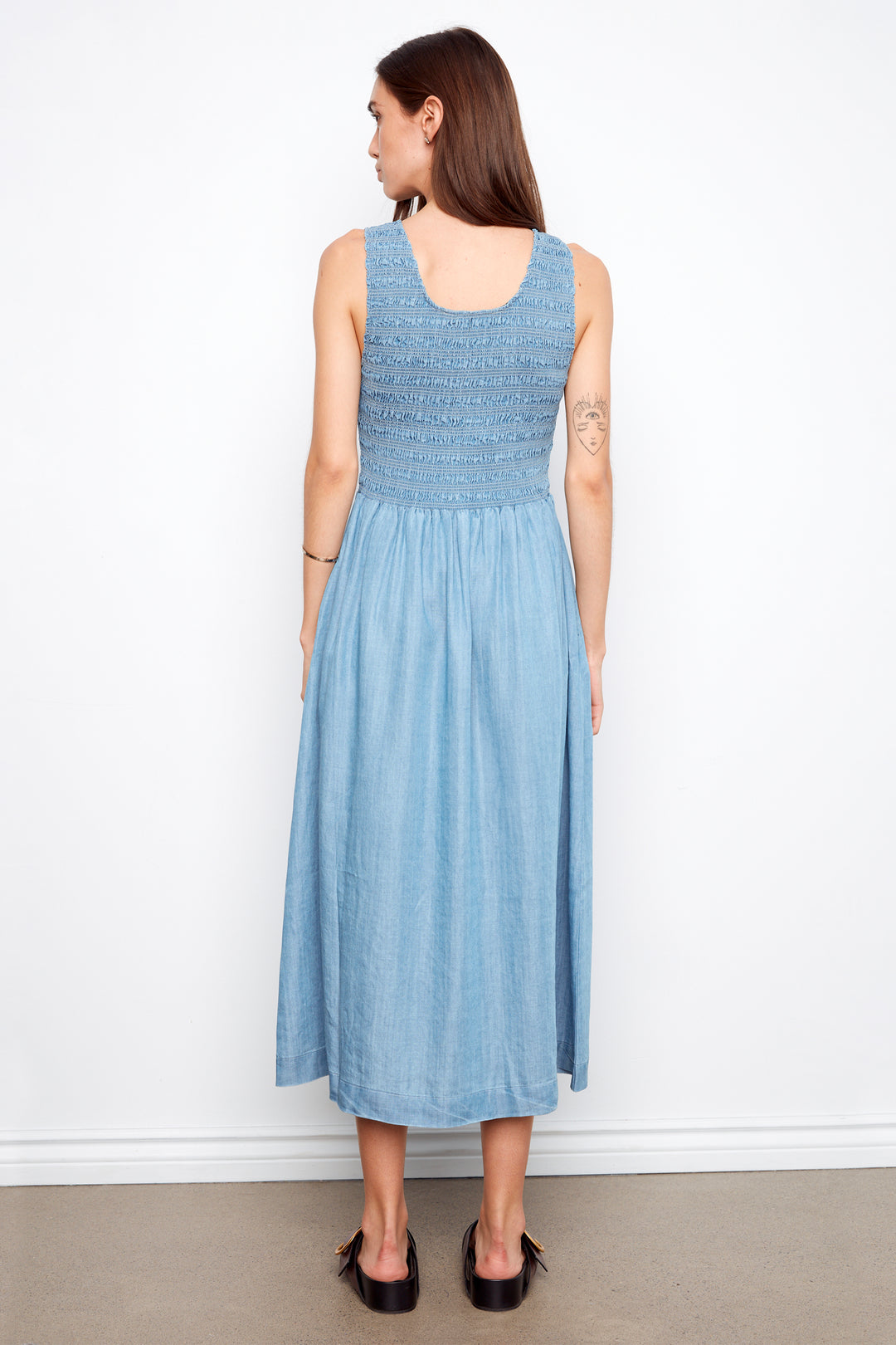 Woman wearing a light blue dress against a white background