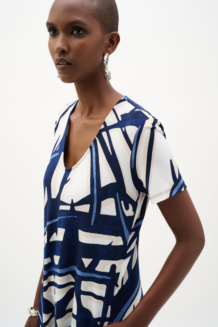 Woman wearing a blue and white patterned dress on a white background