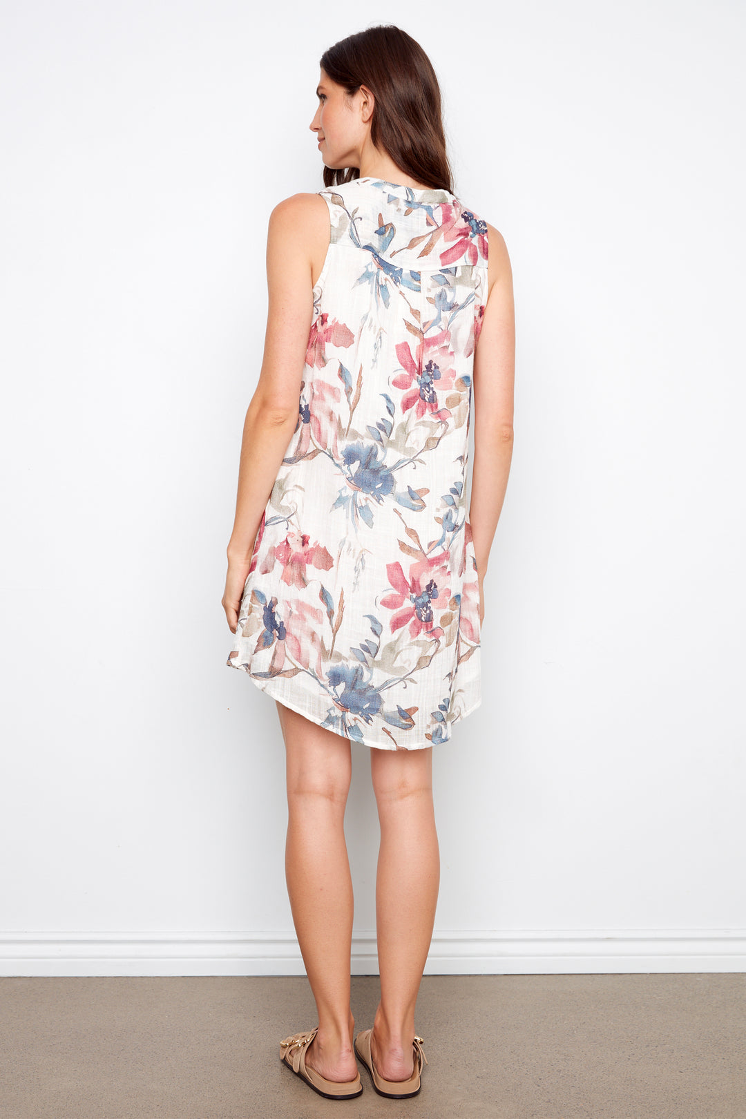 Woman wearing a floral dress against a white background
