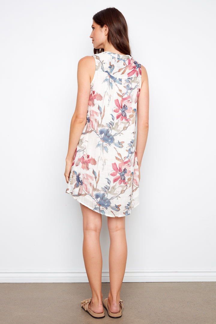 Woman wearing a floral dress against a white background