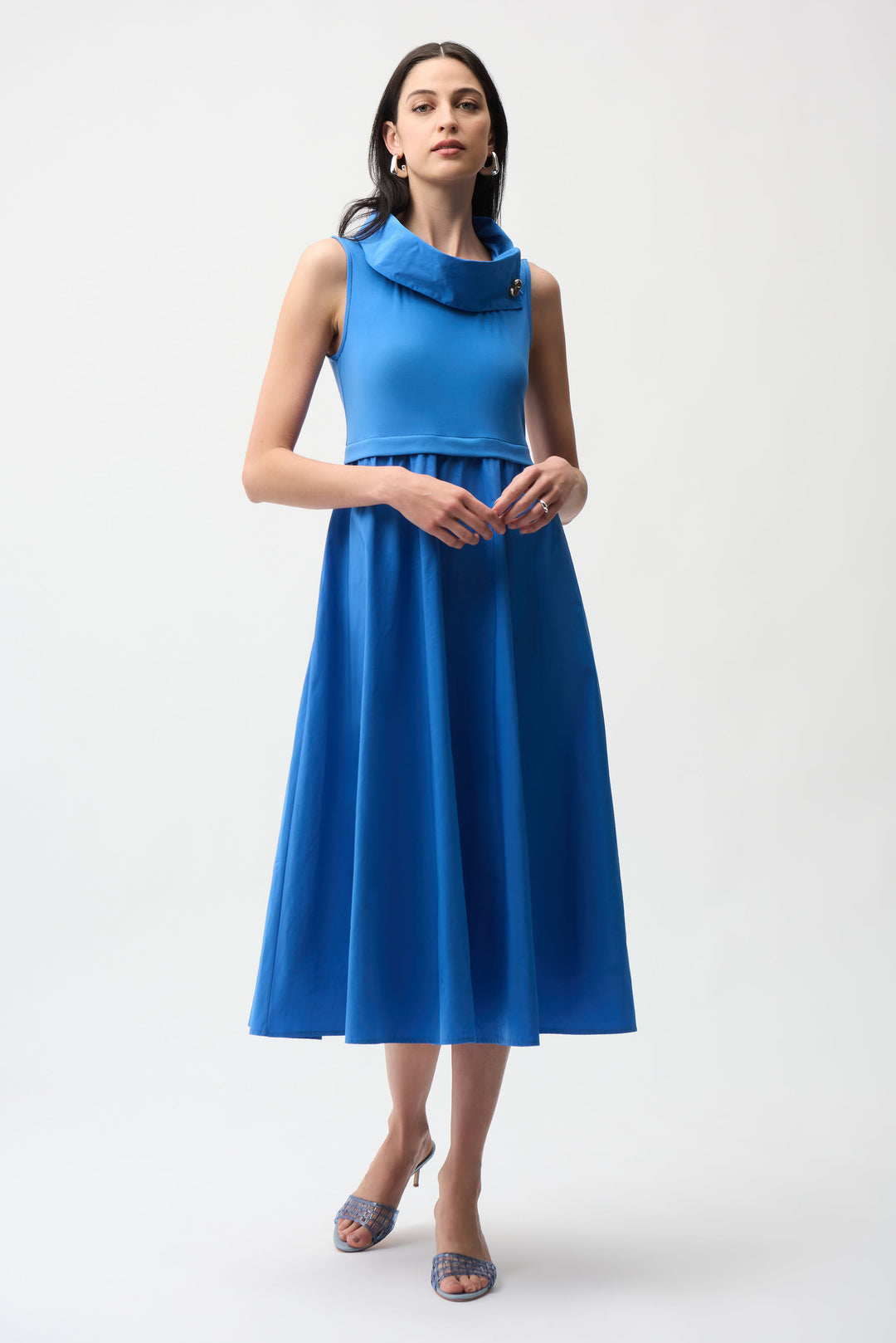 Woman wearing a blue dress on a white background