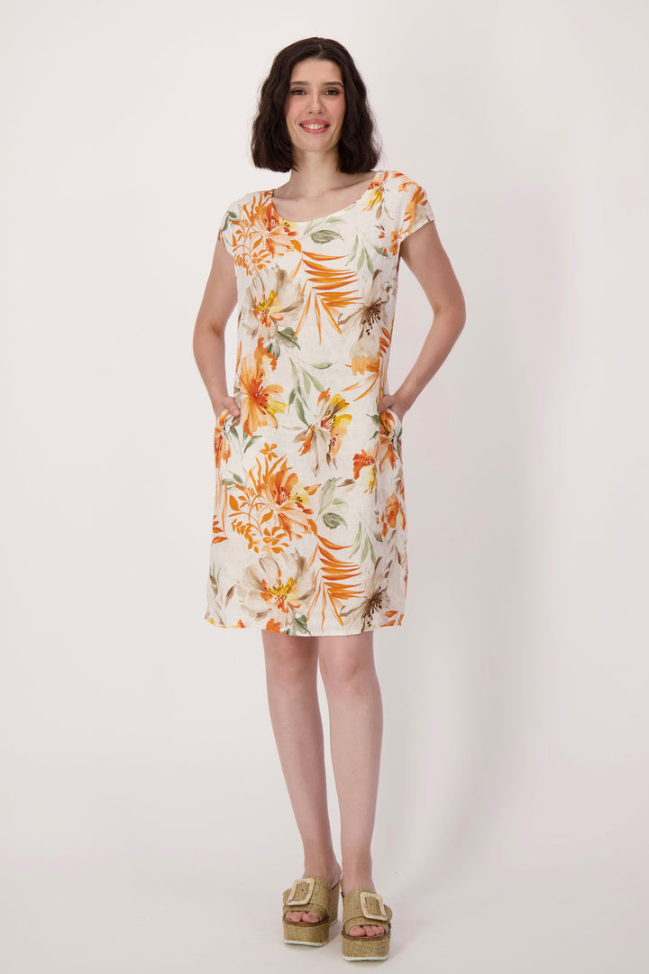 Woman wearing a floral summer dress on a white background