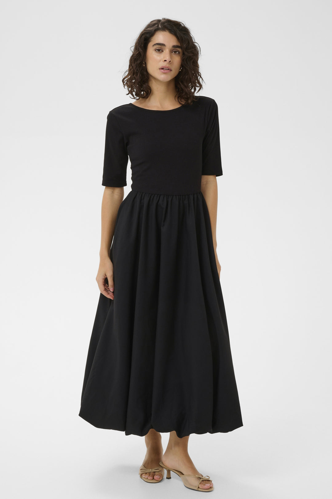 Woman wearing a black dress on a white background