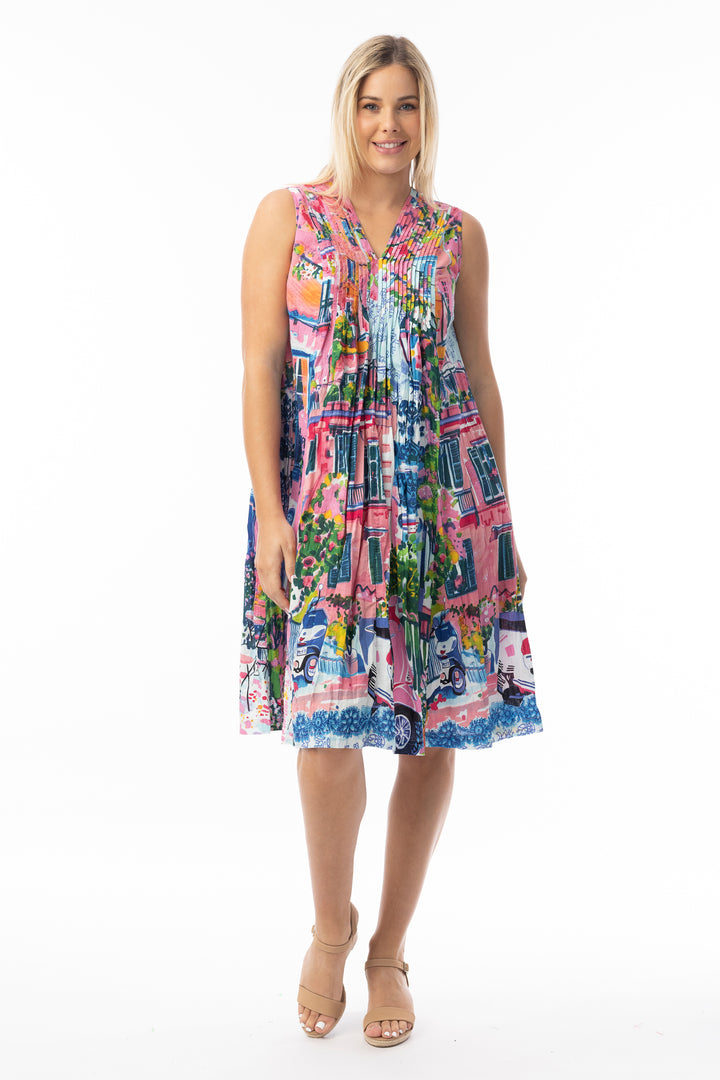 Woman wearing a colorful patterned v-neck dress on a white background