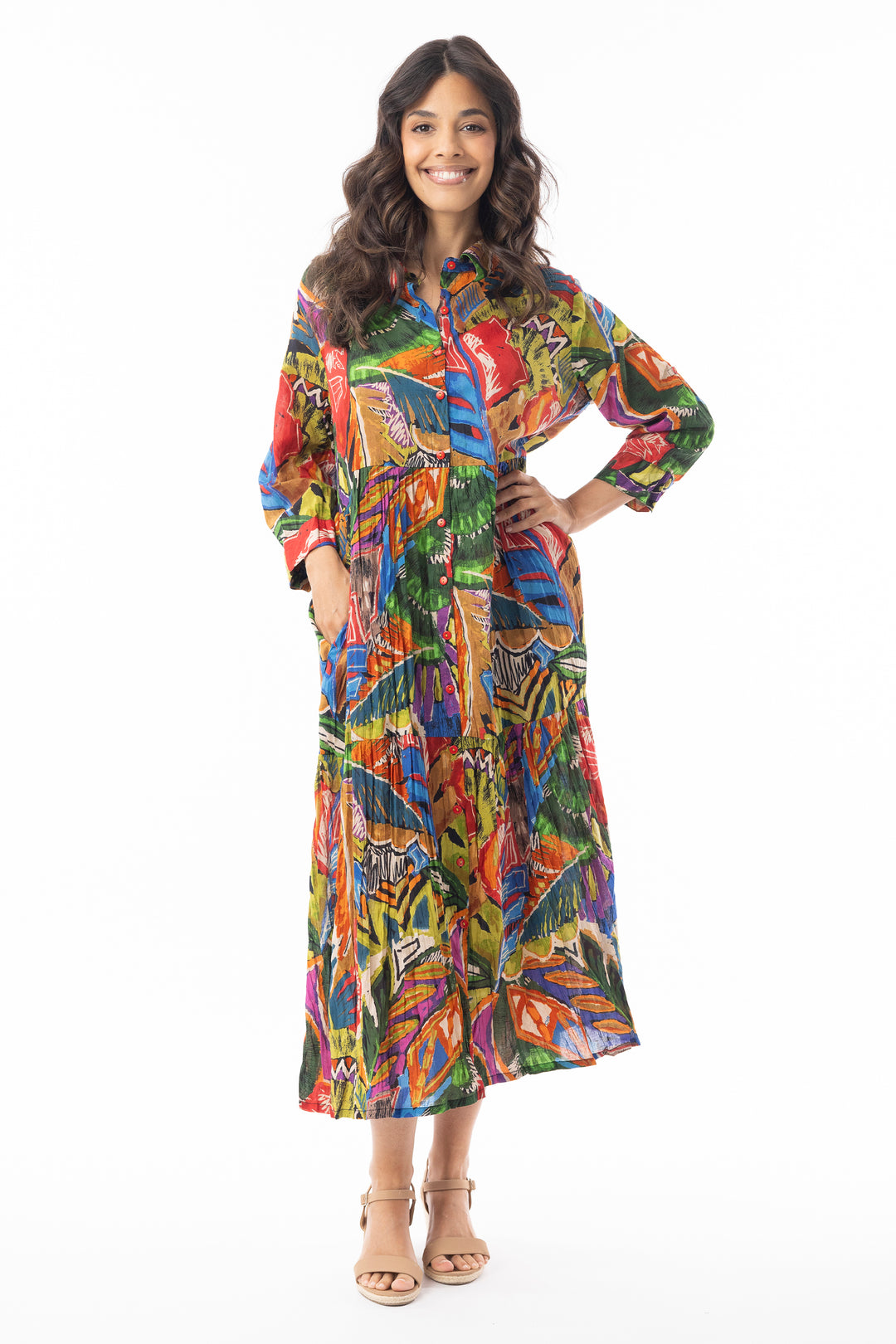 Woman wearing a colorful patterned dress on a white background