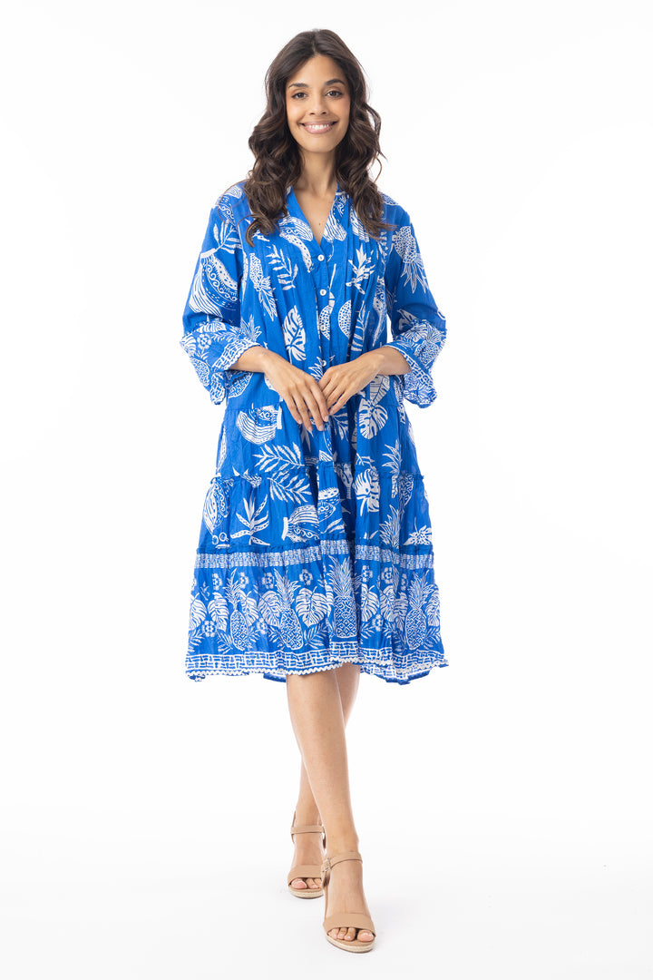 Woman wearing a blue floral dress on a white background