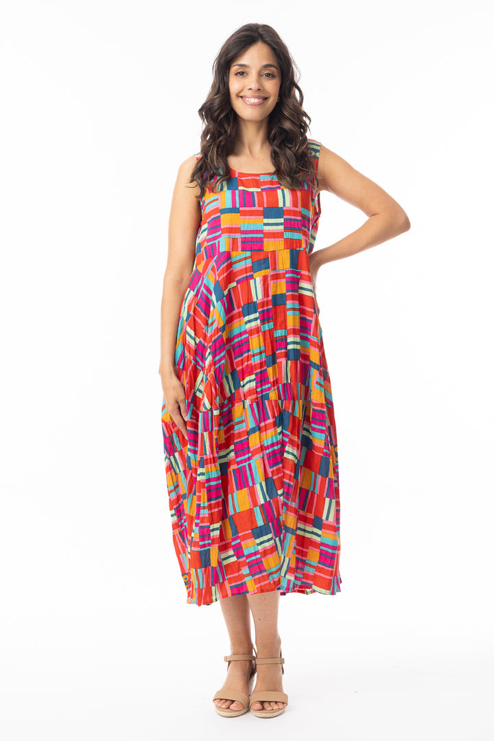 Woman wearing a colorful sleeveless  bubble dress on a white background
