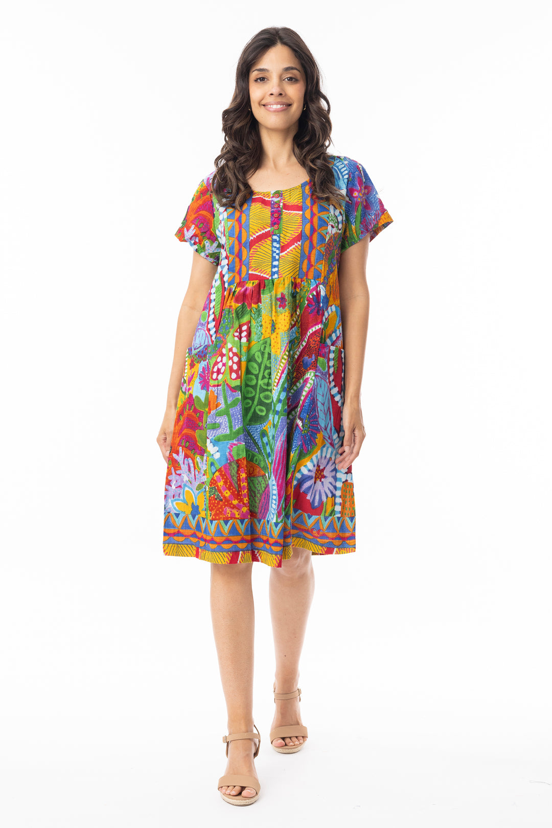 Woman wearing a colorful patterned short sleeve dress on a white background