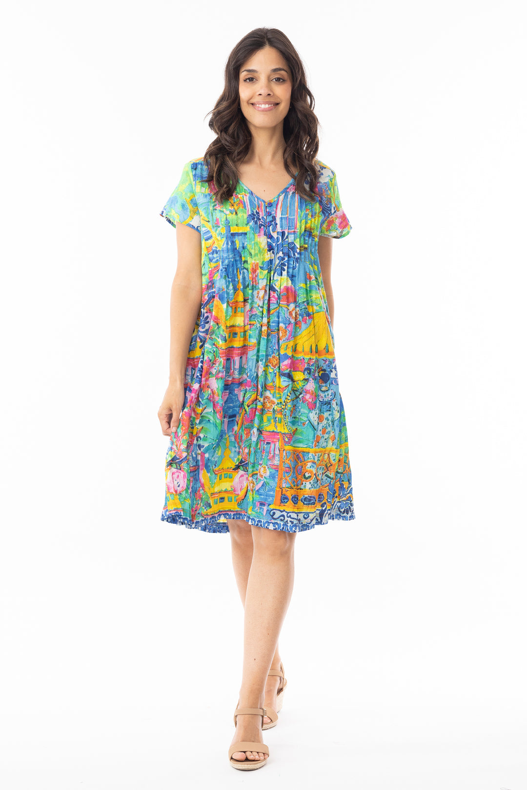 Woman wearing a colorful v-neck dress on a white background