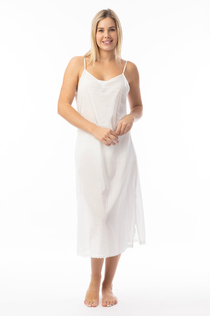 Woman wearing a white slip dress on a white background