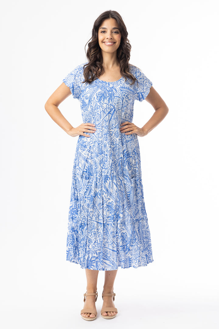 Woman wearing a blue patterned short sleeve cotton dress on a white background