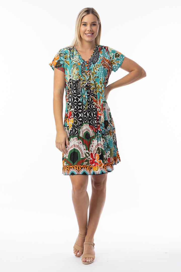 Woman wearing a colorful patterned dress on a white background