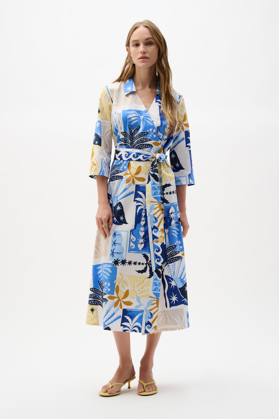 Woman wearing a colorful patterned dress on a white background