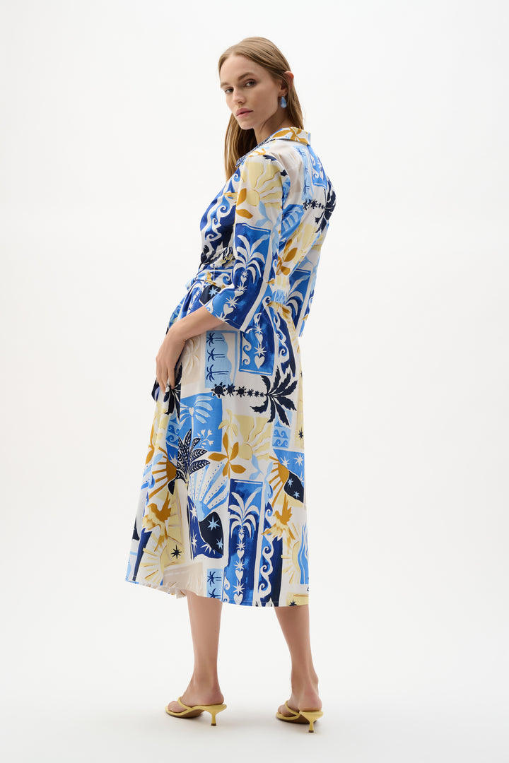 Woman wearing a colorful patterned dress on a white background