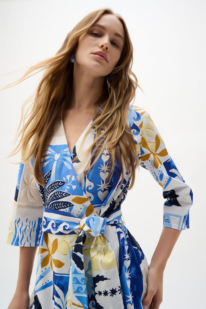 Woman wearing a colorful patterned dress against a white background