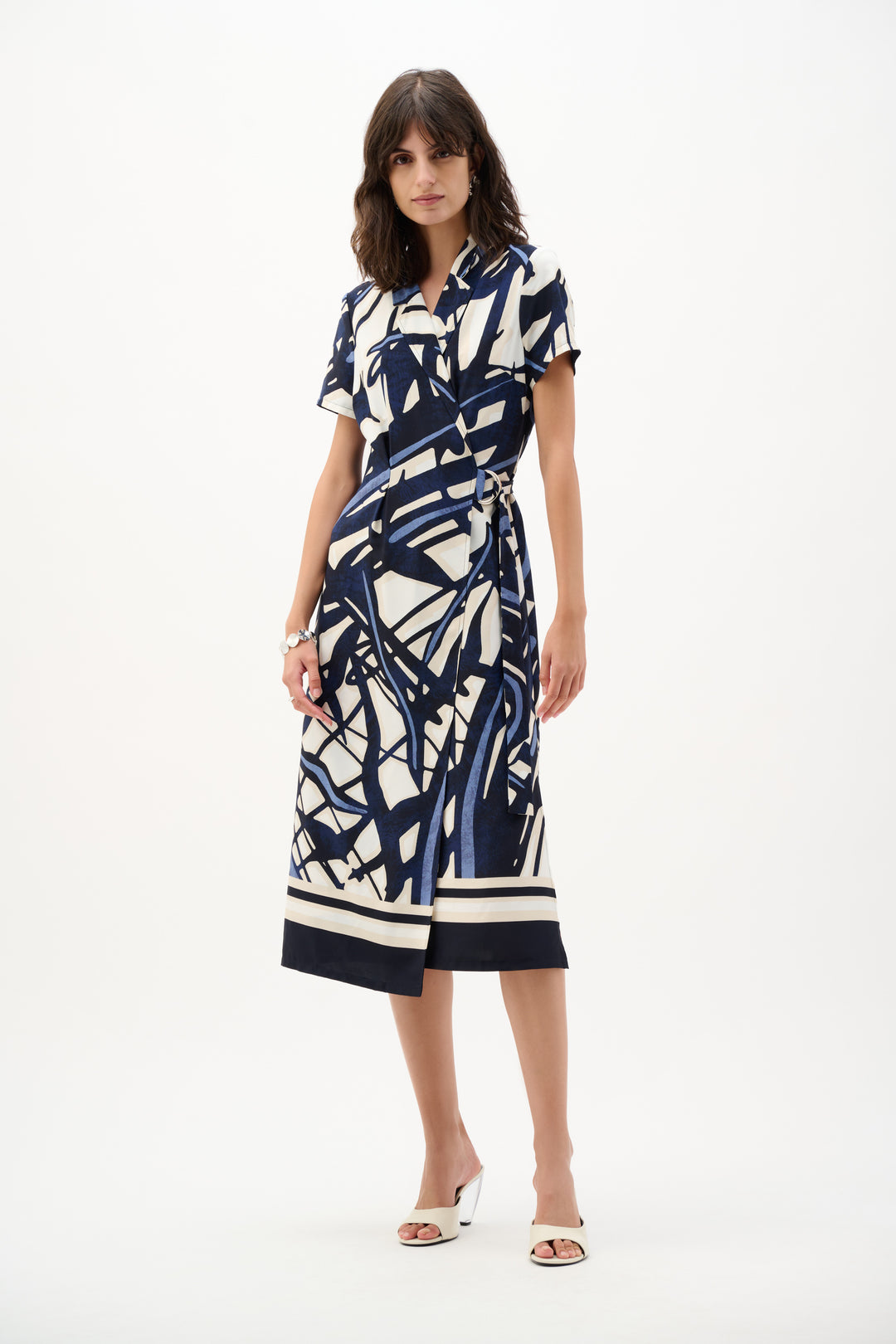 Woman wearing a patterned dress on a white background