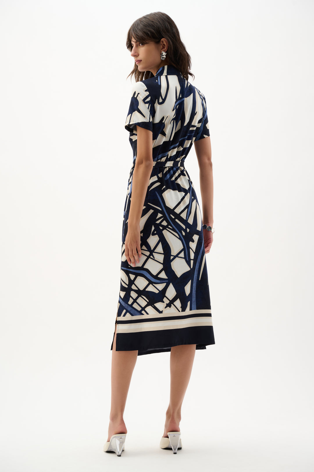 Woman wearing a patterned dress on a white background