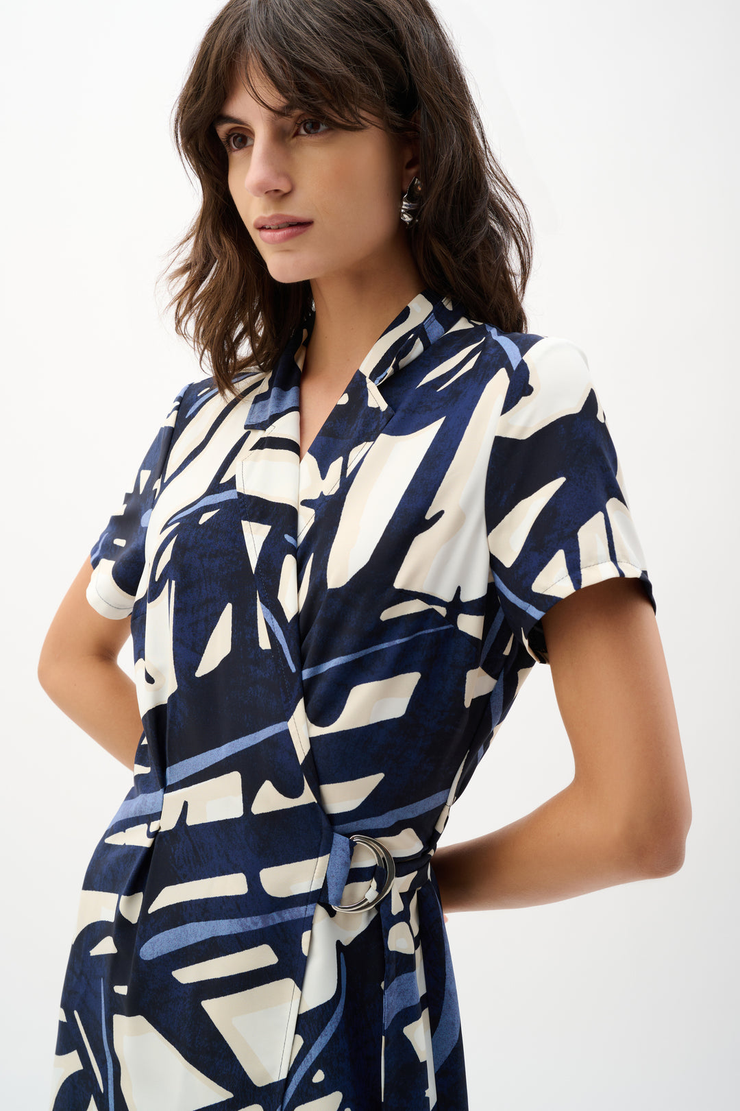 Woman wearing a blue and white patterned dress on a white background