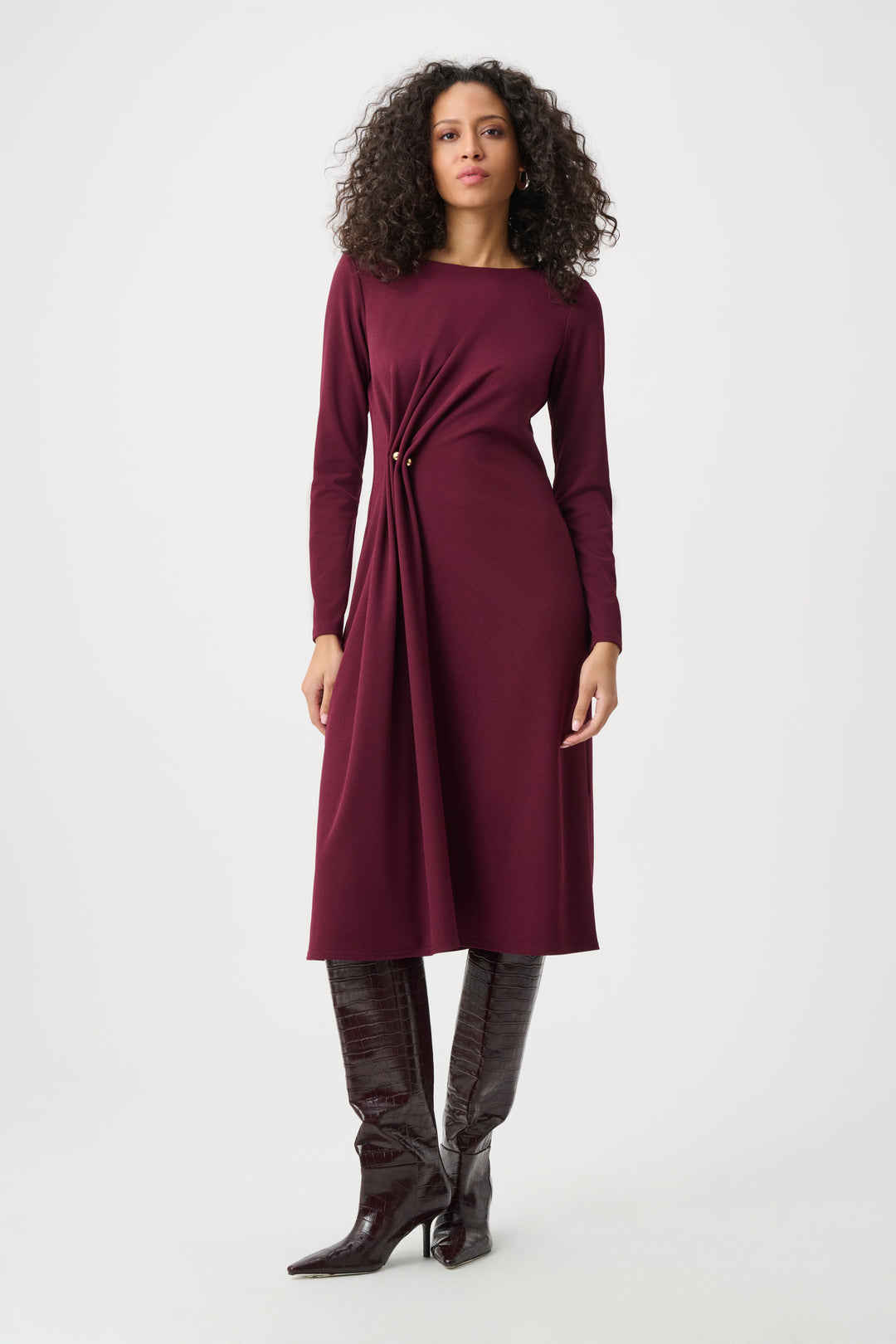 Woman wearing a burgundy dress with a white background