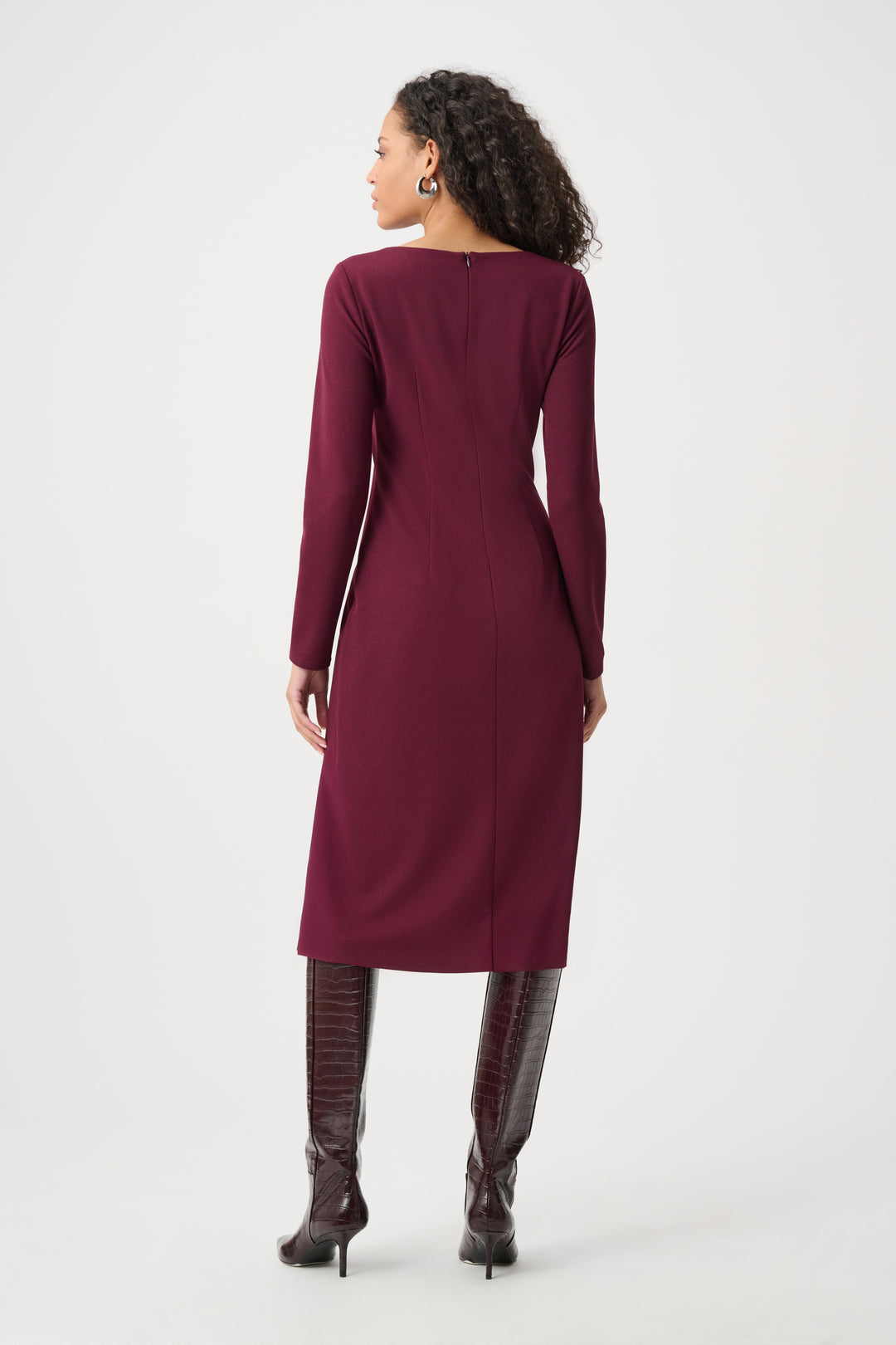 Woman wearing a burgundy dress on a white background