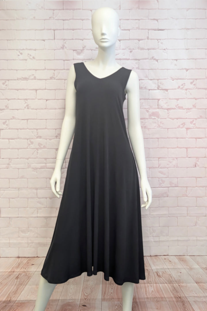 Mannequin wearing a v-neck sleeveless dress in front of a brick background. 