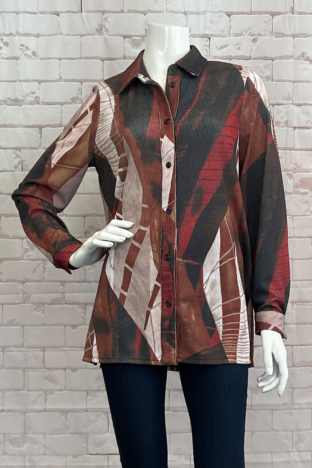 Michael Tyler Fall 2024  Featuring a neat crinkle texture design and double stitch hem, this blouse offers a free flowing fit that will flatter any body type. 