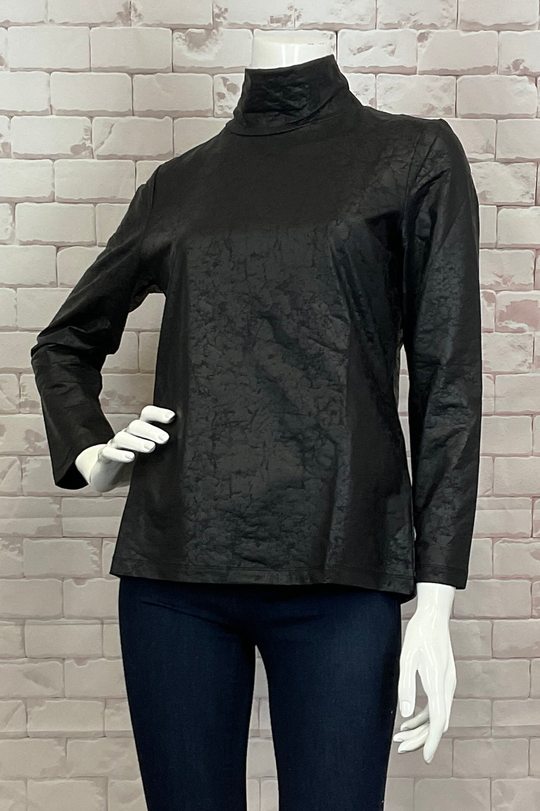 Ever Sassy Fall 2024 Crafted with chic faux leather, its soft texture and full-length sleeves add sophistication. The turtleneck design and crackle fabric create a tasteful, exclusive piece that exudes elegance.