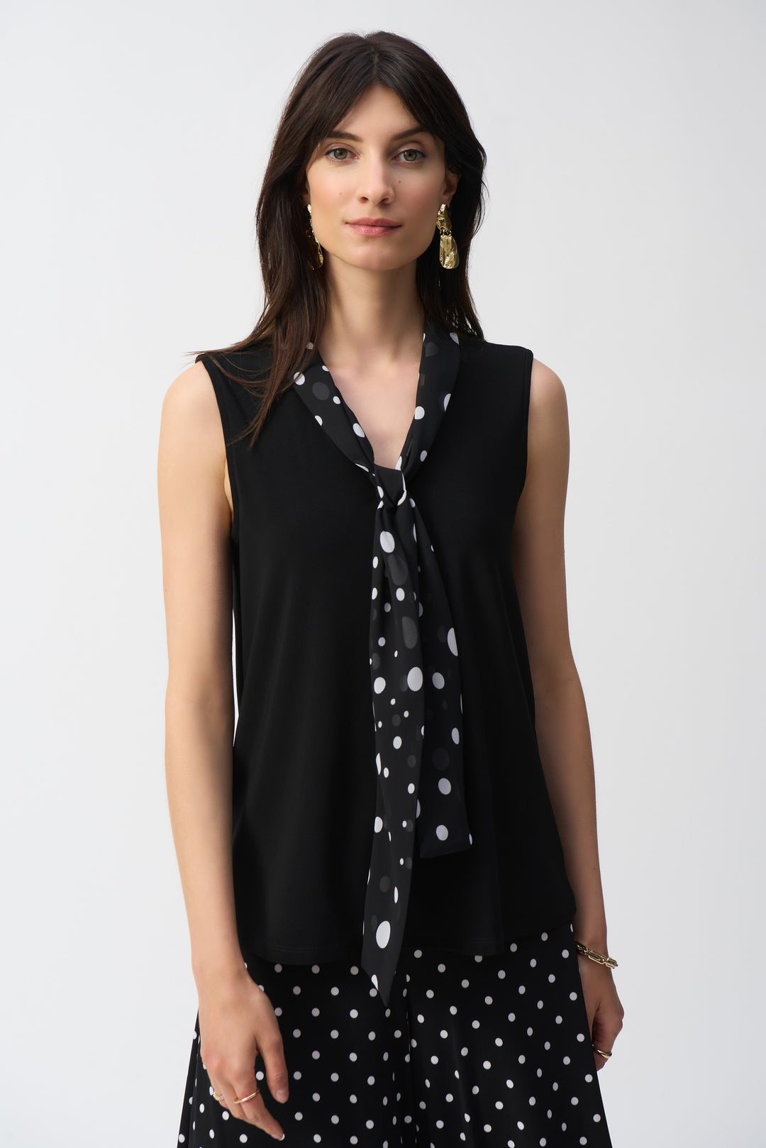 Joseph Ribkoff Spring 2025  The v-neckline adds a touch of sophistication while the silky fabric offers luxurious comfort. The main attraction is the dot tie chiffon scarf, adding a pop of elegance to any outfit! 