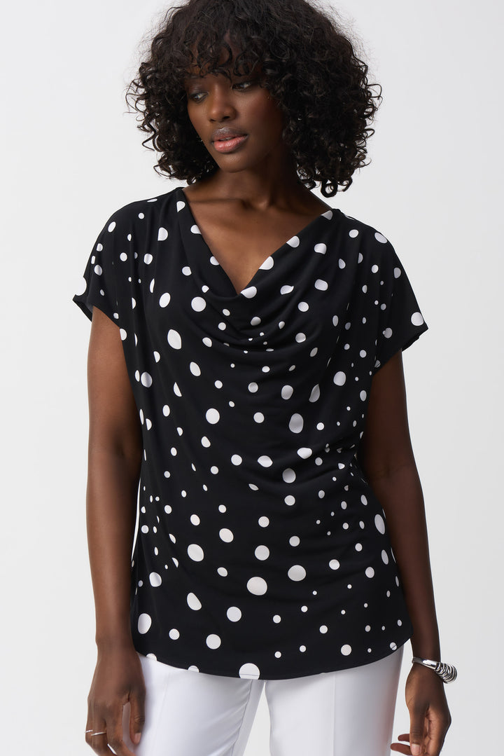 Joseph Ribkoff Spring 2025 With its fun polka dot pattern and flattering drape neckline, this top will add a touch of playfulness to any outfit.