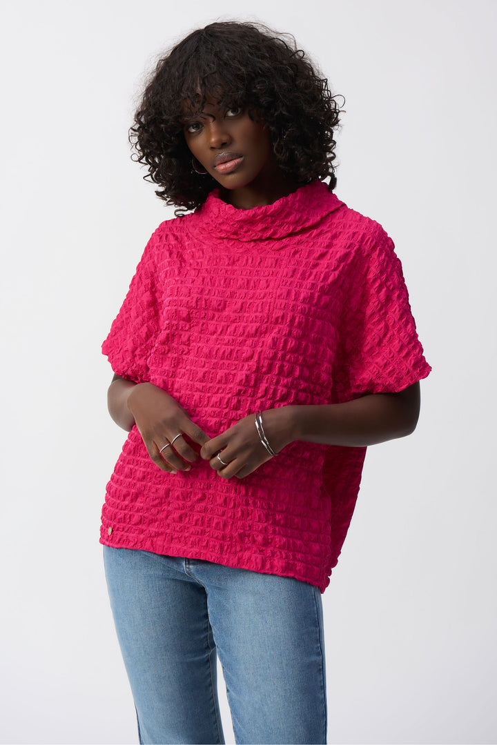 Joseph Ribkoff Spring 2025  The unique textured design adds depth and dimension, while the cowl neck and short sleeves provide comfort and style. 