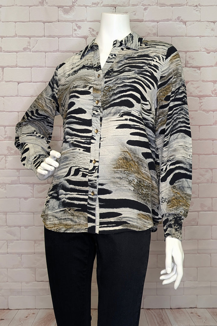 Dolcezza Fall 2025 
Crafted from soft fabric, it showcases an abstract animal print that adds a contemporary edge to a timeless silhouette. Designed with all standard blouse elements, this piece balances sophistication and ease, making it perfect for both professional and more casual settings.