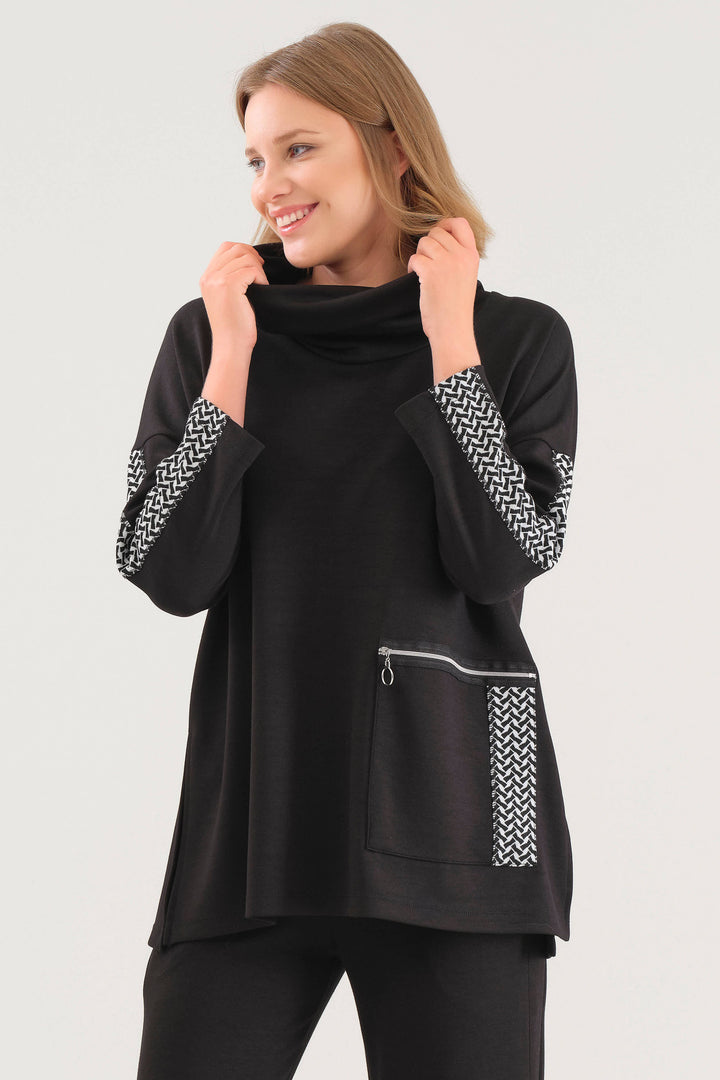 Dolcezza Fall 2025 
Its relaxed, looser fit allows for effortless movement, while the large front pocket adds both style and practicality. Neat contrast trim along the sleeves and pocket gives a refined touch, making this tunic perfect for everyday wear with a sophisticated edge.