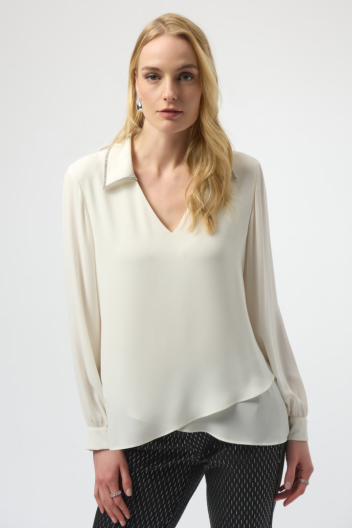 Joseph Ribkoff Fall 2025 
Elevate your wardrobe with the Georgette Popover featuring a stunning rhinestone trim collar. Its sleek V-neckline and asymmetrical cut hem create a refined silhouette, while the silky-smooth, stretchy fabric ensures all-day comfort and a flattering fit. 