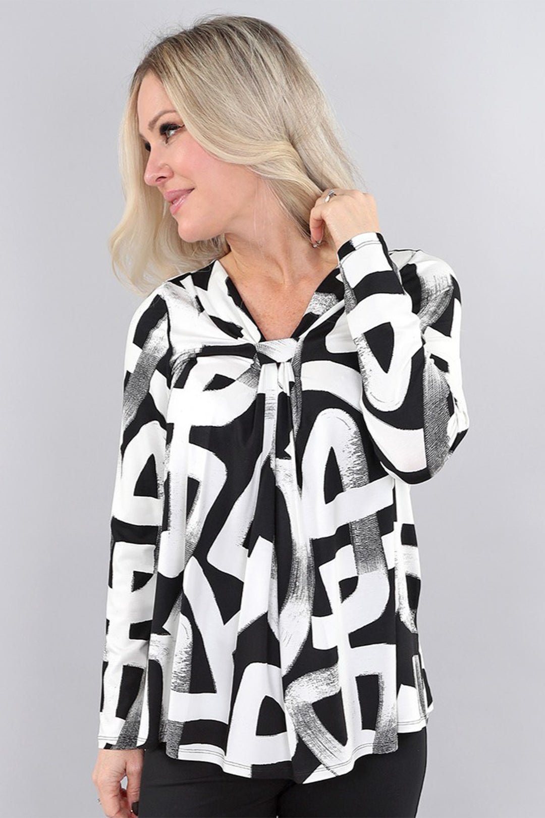 Michael Tyler Fall 2025 
This abstract bold print tie-neck top offers a sophisticated touch to your office wardrobe. Crafted from super lightweight, soft fabric, it ensures all-day comfort. The double-stitched hem and cuffs add durability while maintaining an elegant finish.