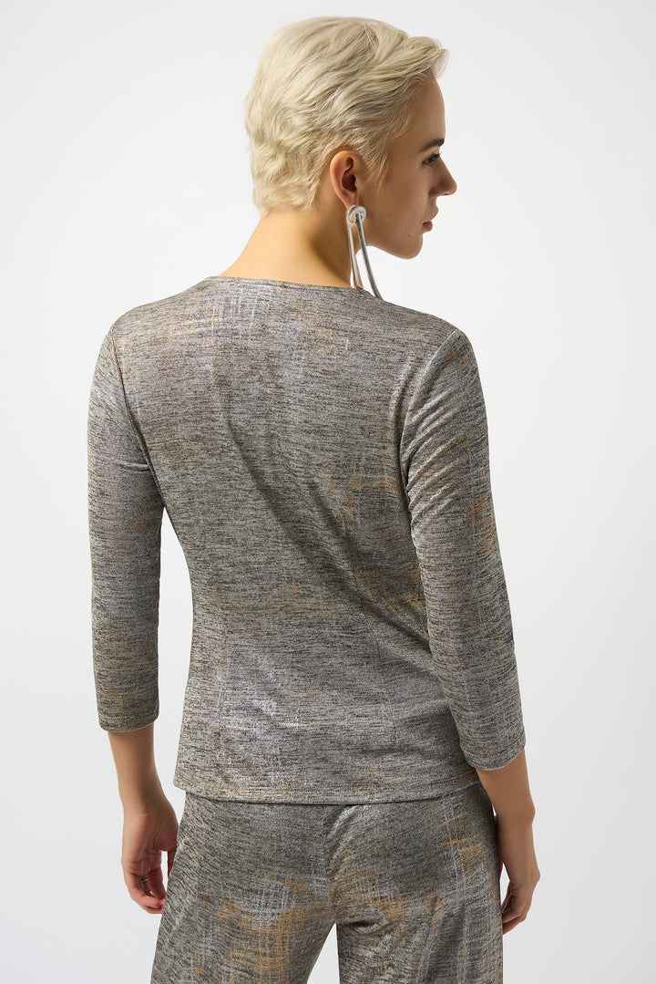 Woman wearing a gray long-sleeve pullover top and pants on a white background