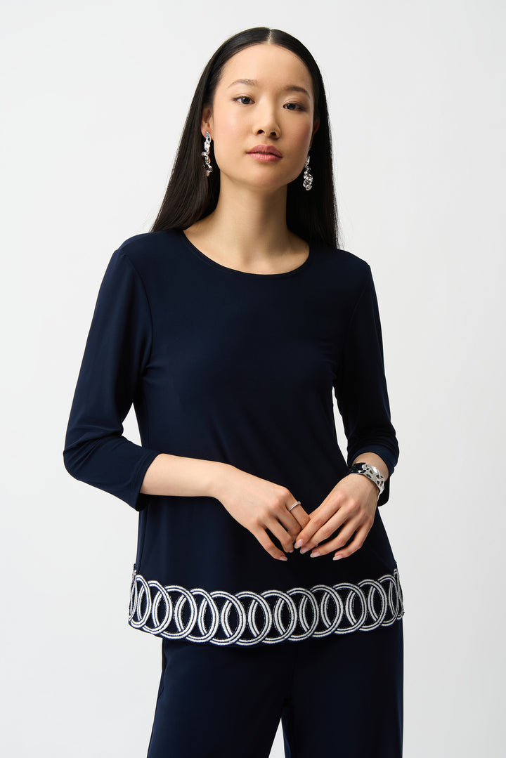 JOSEPH RIBKOFF Spring 2026 
Elevate your everyday wardrobe with this stunning 3/4 sleeve top, where interlocking circles dance along the hem to create an eye-catching focal point. The light, loose silhouette offers effortless comfort while the crew neckline keeps things classic and versatile. 