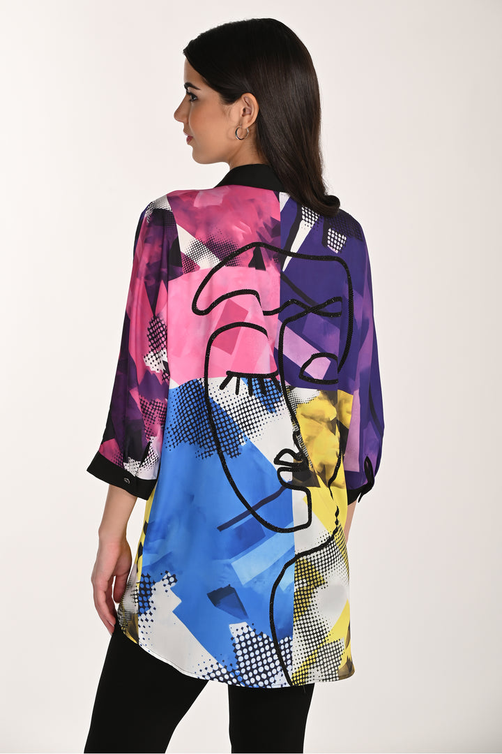 Woman wearing a colorful abstract patterned button blouse on a white background