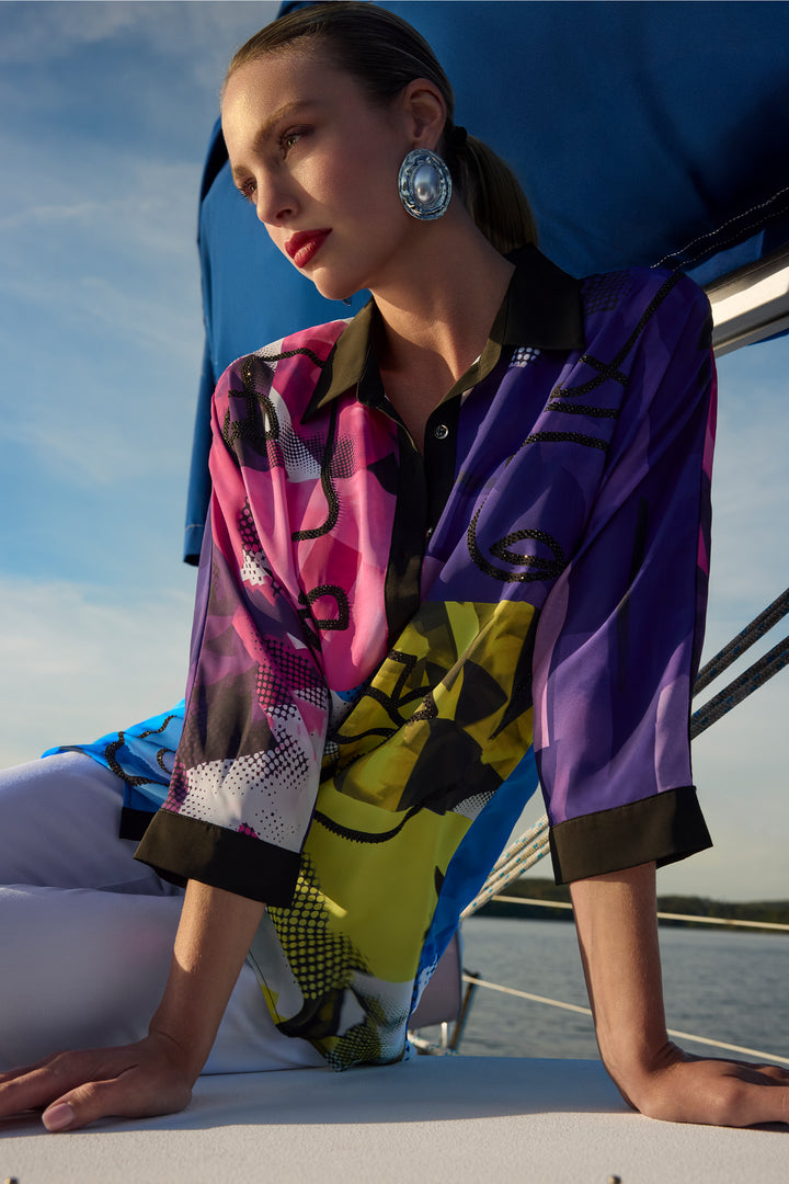 Woman wearing a colorful patterned button blouse with classic collar on a boat