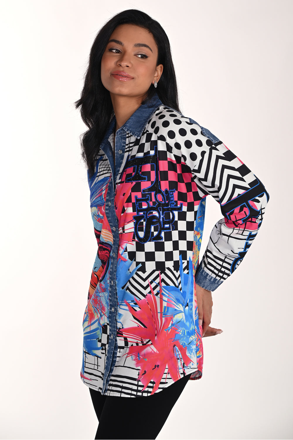 Woman wearing a colorful, patterned abstract face tunic blouse with a white background