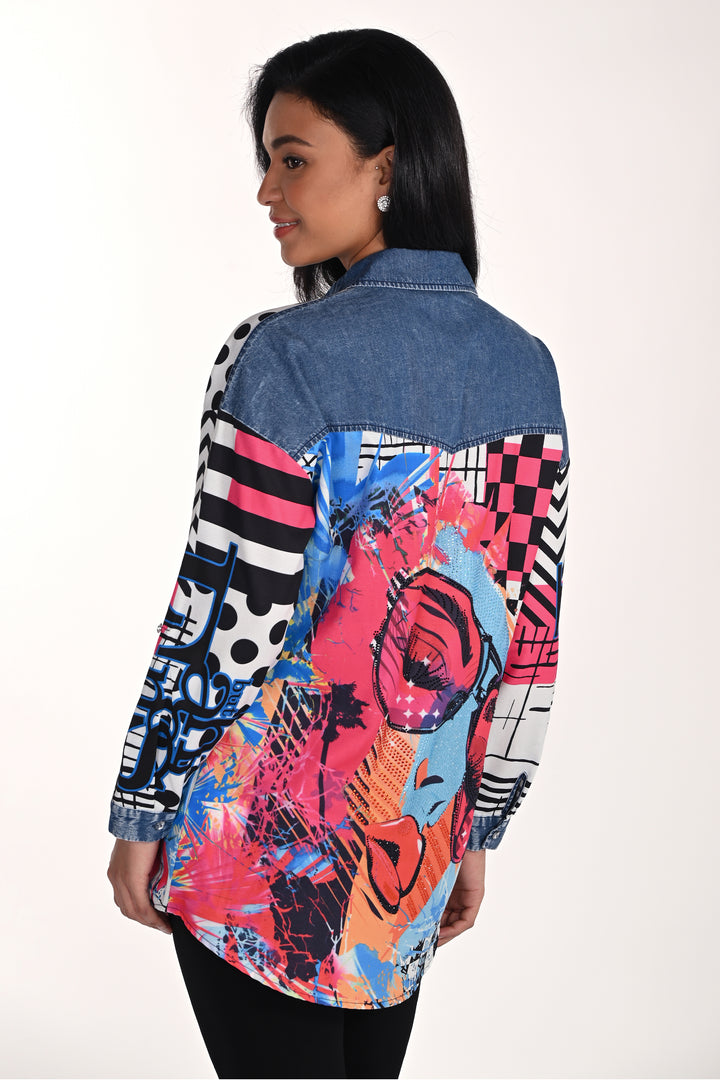 Woman wearing a colorful, patterned tunic blouse with a denim collar on a white background